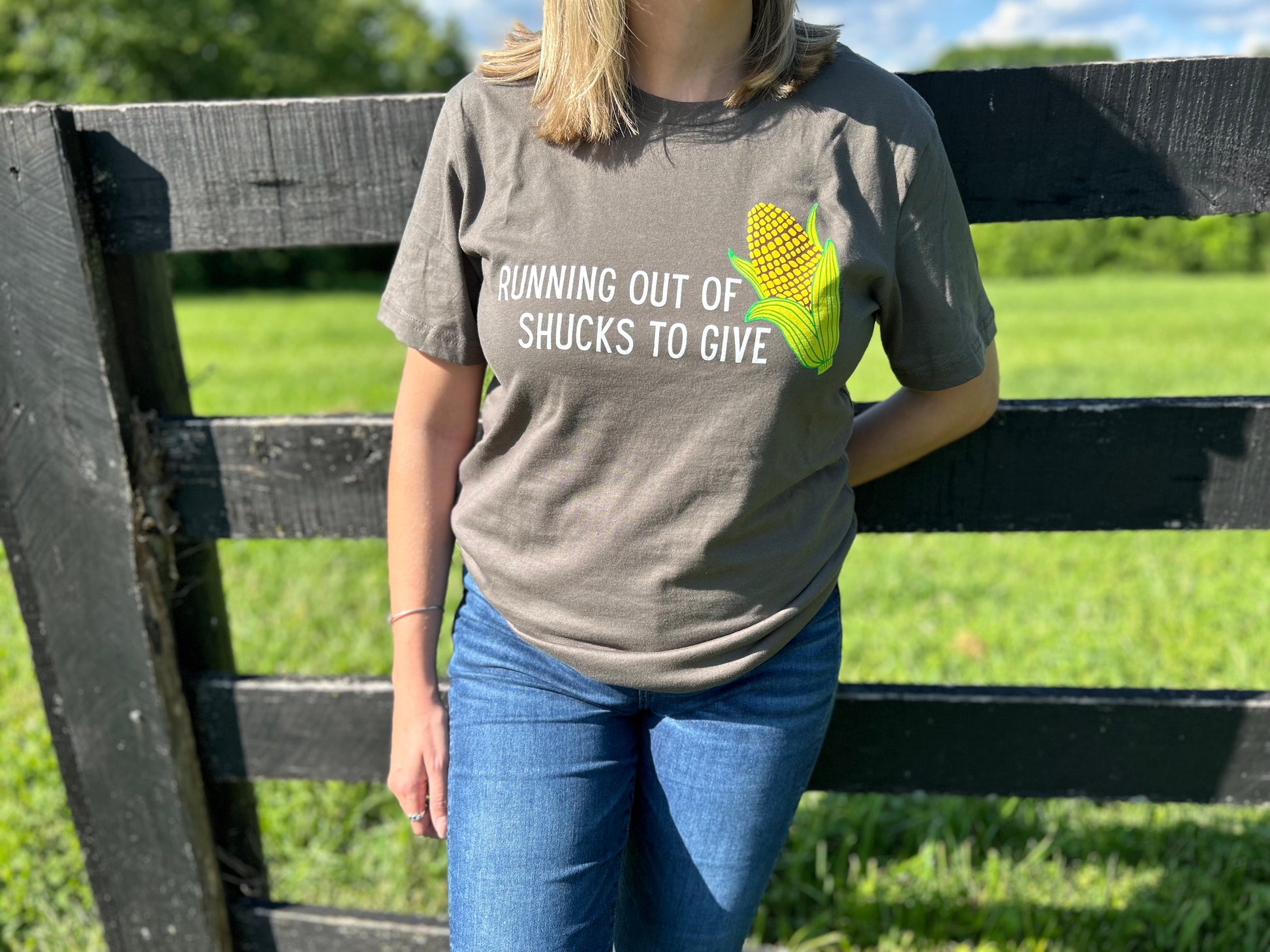 Running Out of Shucks T-Shirt by Pink Tractor, 100% ring spun cotton unisex tee with 'Running Out of Shucks to Give' design.